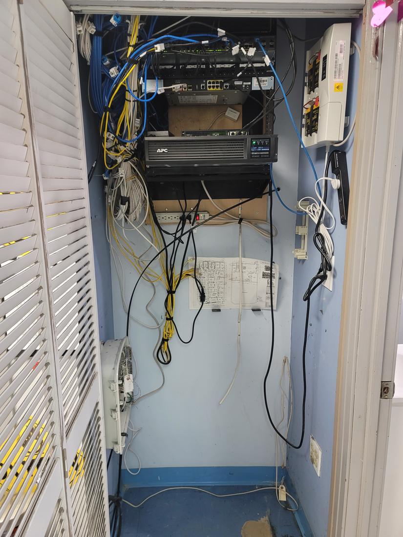 After: Medical office IT closet: rebuilt with an organized rack and battery backup