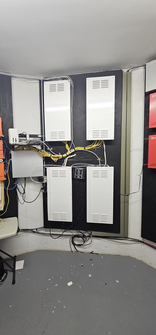 After: Low-voltage room: new enclosures with cable runs bundled and closed up